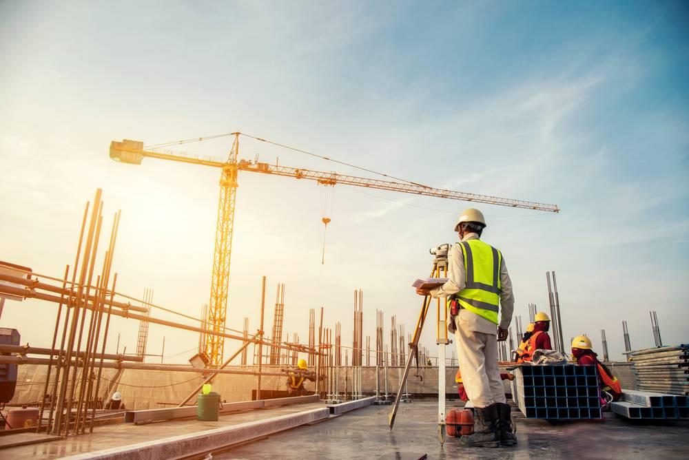 Tower crane and site crew at sunrise